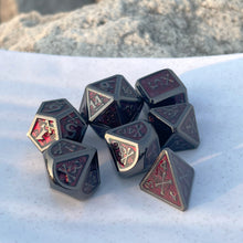 Load image into Gallery viewer, Gothic Skulls Dice Set Inked in a glossy blood finish with a relief featuring skulls and bones on dice with a gun metal finish, these dice are the perfect companion to a game master running a horror campaign (be it Gothic, Cosmic, or Hammer), or to a player playing assassins, vampires, or murder hobos. These dice really capture the essence of a morbid, grimdark setting.