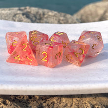 Load image into Gallery viewer, Summer of the Fey Dice Set These glittery dice are reminiscent of cherry blossoms, fairies, and summer flowers. Their easy-to-read numbering is inked in a noble looking gold color. These dice would be perfect companions to any character with connections to the fey, or with an affinity for flowers.