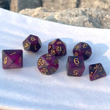 Load image into Gallery viewer, Eldritch Galaxy Dice Set These dark and swirling purple dice allow you to hold a nebula in your hand. Each speck of tiny glitter is a star or world for you to consider. The rich purple swirls and gold inking appear both regal and mysterious. These are perfect for characters that hide in the shadows, commune with eldritch forces, or descend from nobility.
