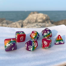Load image into Gallery viewer, dnd dice Adventuring is a lifestyle that attracts a diverse cast of proud and daring heroes who fight against the forces keeping their fellows down. Regardless of creed or color, these dice symbolize a commitment to uphold the virtues love, camaraderie, and bravery. Wield these dice proudly as you cast them against the forces of evil.